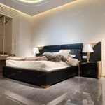 Black Leather Upholstered Bed with Textured Gold Accents, Patterned Quilted Detailing & Brass Hardware Feet